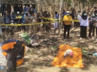 Personel kepolisian tengah mengamankan lokasi penemuan mayat seorang karyawati rumah makan di area perkebunan warga. Foto: Istimewa